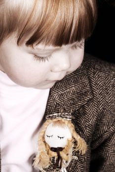 Toddler girl with chubby cheeks wearing a stylish jacket