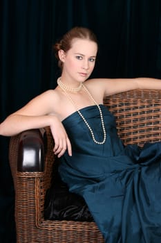 Beautiful female wrapped in fabric, wearing pearls 