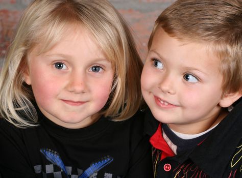 Beautiful young girl with blond hair and her cute boy friend 