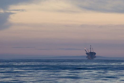 off shore oil drilling rig at sunset