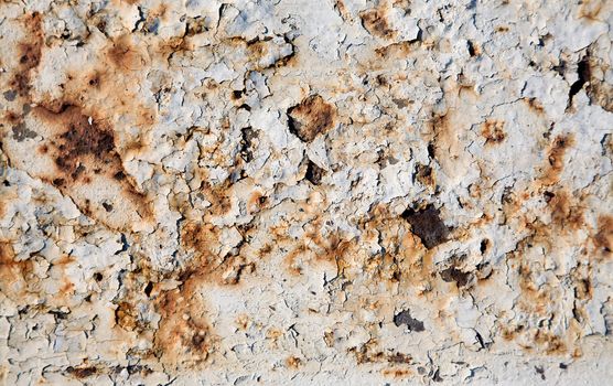 The painted grunge rusty wall with cracks