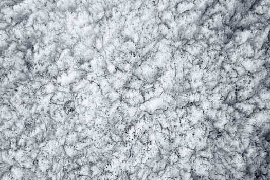 Surface of the spring, cracked ice on lake