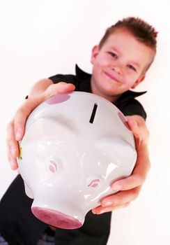little boy is holding his piggy bank