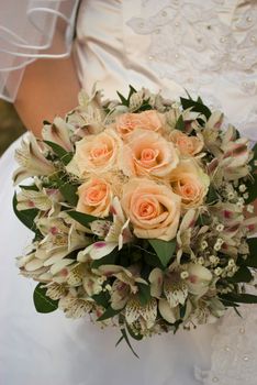 wedding bouquet with roses in bride's hands