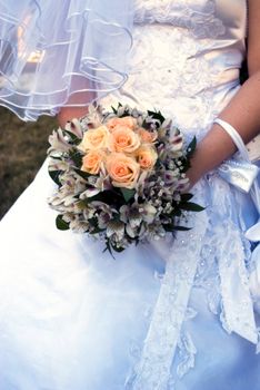 wedding bouquet with roses in bride's hands