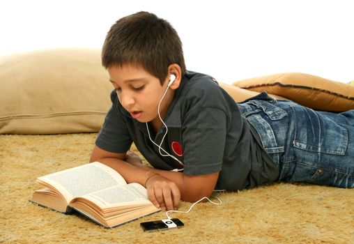 Boy studing laying down and listening with a mp4 player