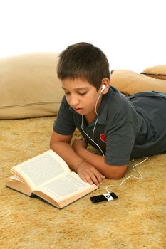 Boy studing laying down and listening with a mp4 player