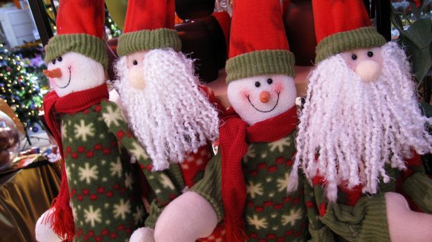 four people in santa claus look are celebrating christmas