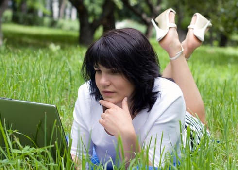 Woman with laptop in park