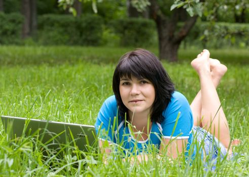 Woman with laptop in park