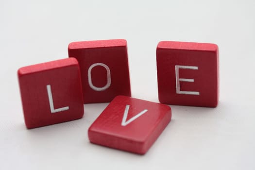 Red wooden letters, spelling the word "love"