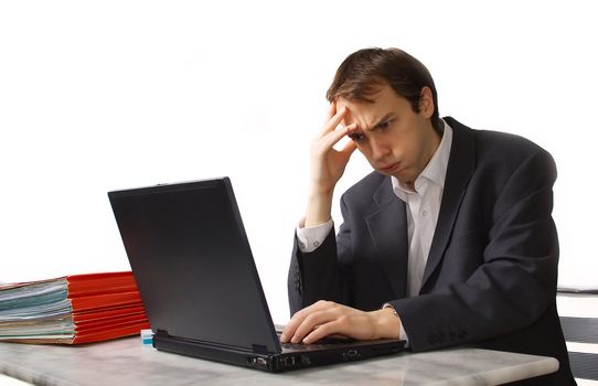 Young man works on laptop, close to breakdown, isolated over white