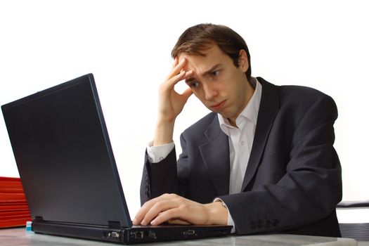 Closeup stressed Young man works on laptop, isolated over white