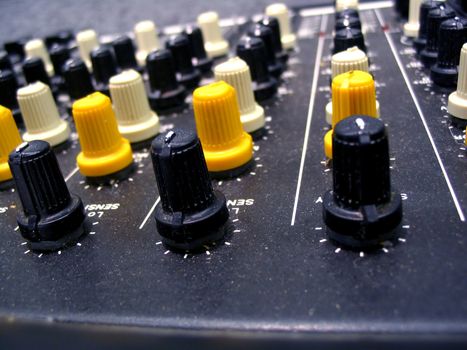 This is a macro shot of a studio mixing board showing a close up of the tuning knobs. 