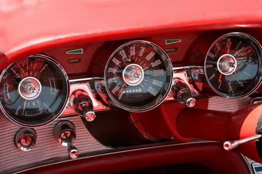 This is a dashboard from the inside of a classic car showing the gauges.