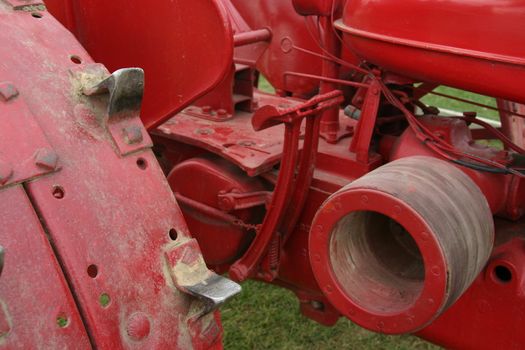 This is a picture of the inner workings of a farmer’s red farm tractor.