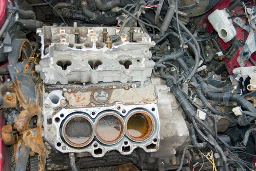 This is an engine block in a stolen sports car that has been stripped of all useable parts.