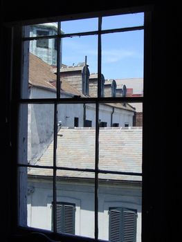 This is a view from a popular restaurant in New Orleans Looking out at a roof line of the building next door. 