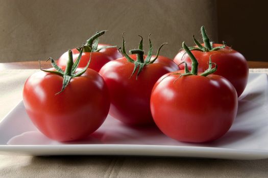 Fresh Vine Ripened Tomatoes on a white plate.
Red Tomatoes hand picked for the grocery market
These will add fresh ingredients to your vegetable list