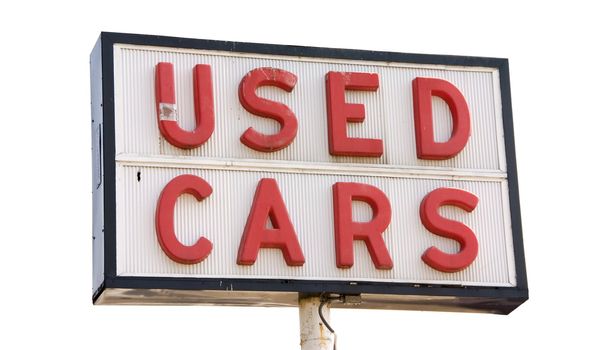 This is a picture of an old used cars sign with red letters, isolated on a white background.