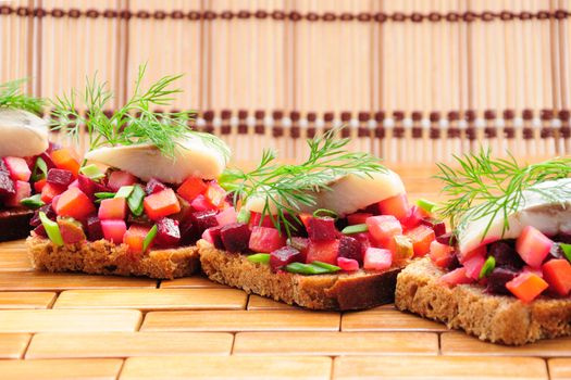 Sandwiches with rye bread, herring and vegetables