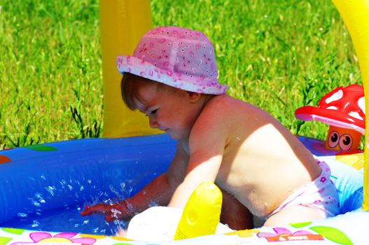 child in to pool. Child making splash in to pool. Focus on the splash