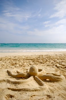 A octopus sand sculpture on a beach