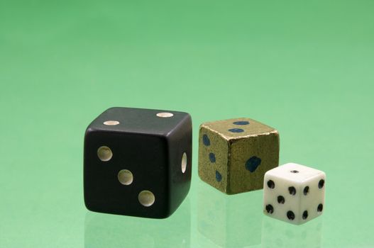 
	
Dice of various sizes and colors are on the green background