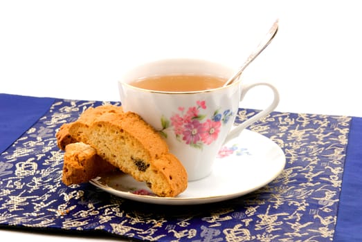 
	
A cup of tea in Chinese porcelain and dry biscuits 