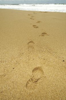 Footsteps at beach on a stormy day