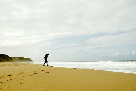 Man walking towards the waves