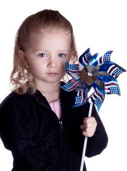 A lonely girl holding an American flag windmill.