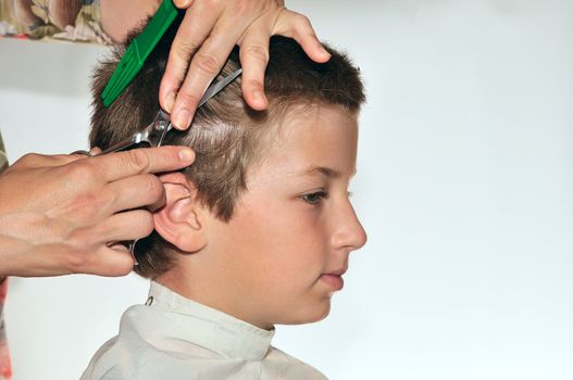 
Hairdresser clipper boy harboring his cloak from falling hair