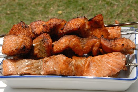 
Salmon is grilled in a white ceramic dish