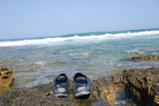 
	
people went to bathe in the sea left the slippers on rocks on the shore