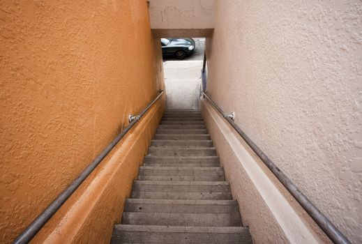 Long stairway to street where car is parked