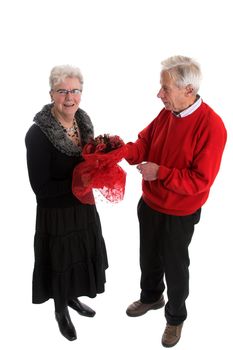 Pretty elderly lady getting a bunch of red flowers from her husband for valentine day