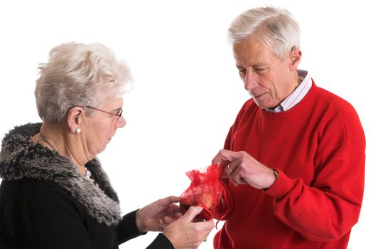 Elderly couple celebrating Valentine's day by giving chocolates