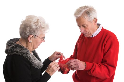 Elderly couple together holding a box of chocolate