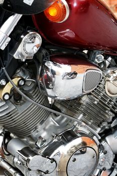 The engine of a motorcycle with a red petrol tank