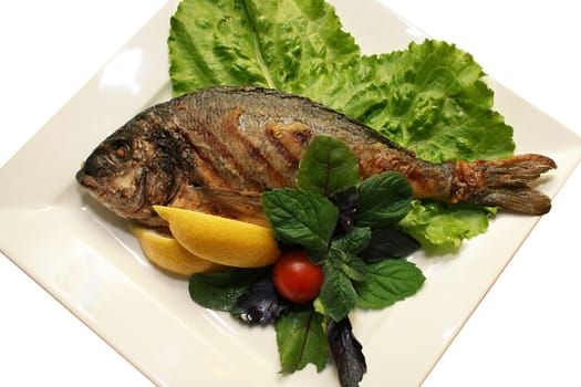 The prepared fish with vegetables on a plate