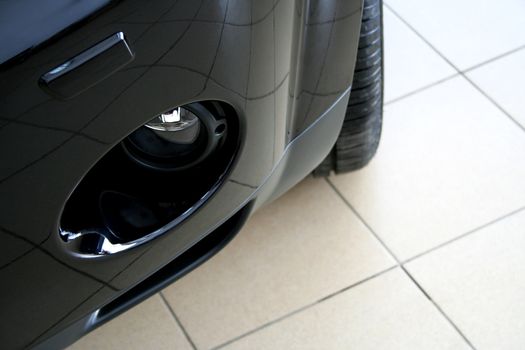 The black sports car on ceramic to a floor