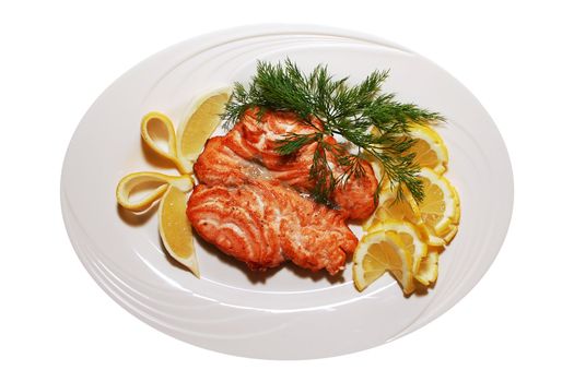 The prepared fish and lemon on a white plate