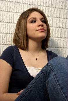 A pretty teenager with brunette hair.