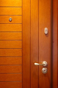 Wooden door with the lock and a spy hole