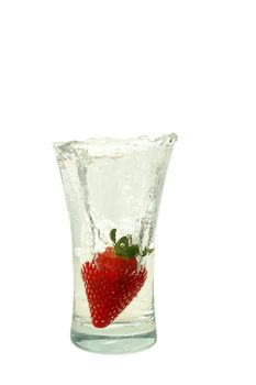 Big fresh strawberry in glas with bubble water isolated