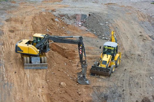 works in an industrial zone in construction witch excavator machines