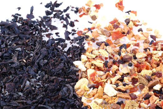 Close up of some black tea and some fruit tea, isolated on white.                