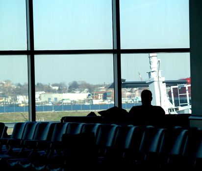 a man waits at the airport for his flight