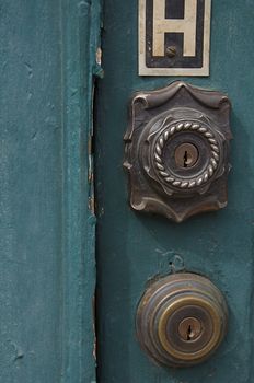 An old door has a distinct metal lock.